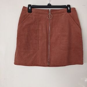 Dusty rose pinkish orange zip front skirt.